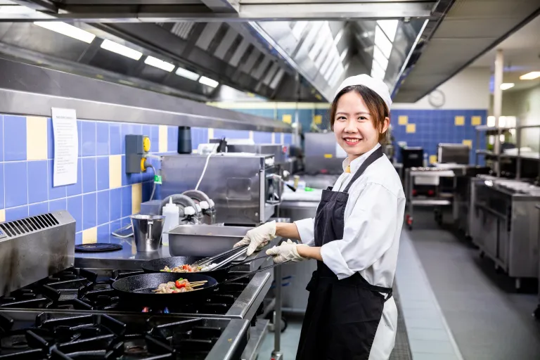 Culinary arts student in commercial kitchen