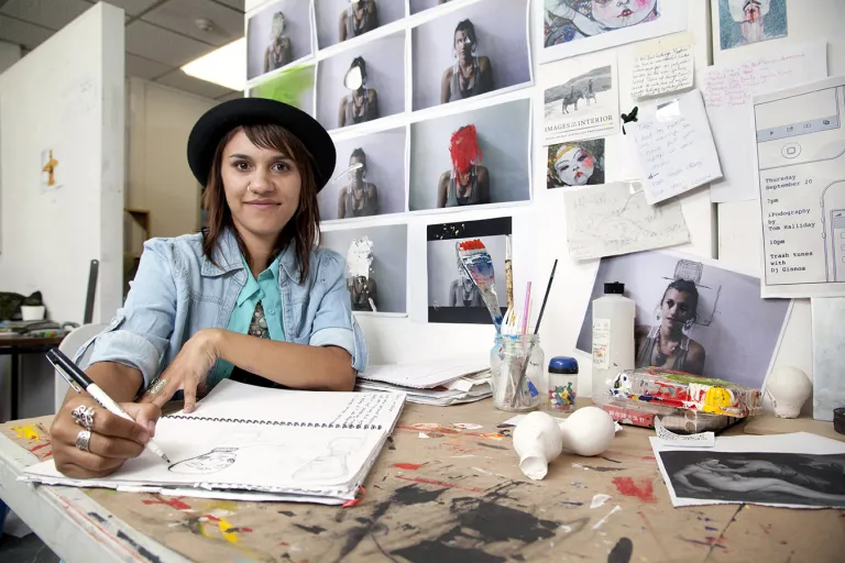 Creative arts student drawing in workshop