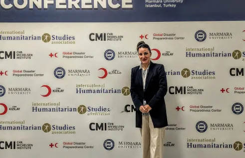 Dr Adriana A. Stibral at the IHSA conference in Istanbul (in front of IHSA conference banner)
